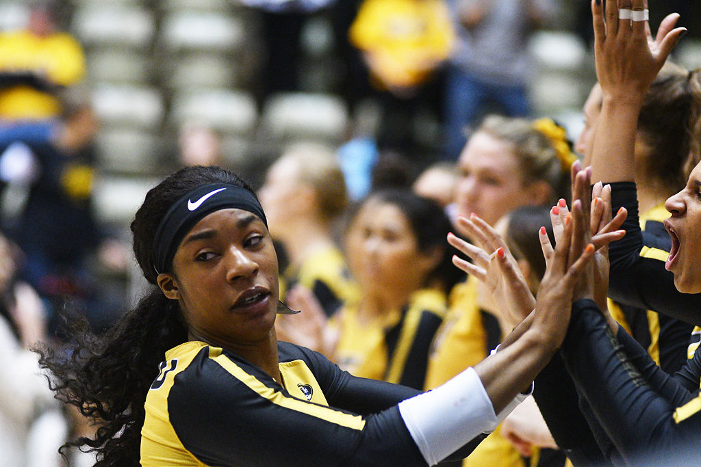 Missouri outside hitter Leketor Member-Meneh high fives her teammates while being introduced before their game against Ole Miss